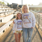 💜 Details:

Light heather gray fleece crewneck

Bold graphic with Sumner Spartan mascot, cheer icons, and playful doodles

Unisex fit – true to size for a comfy, relaxed feel

Available in sizes S–XL
