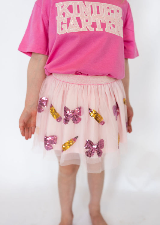 Details:

Light pink tulle overlay with pink bow and gold pencil sequin appliqués
Soft elastic waistband for a comfortable fit
Fully lined so it’s never itchy
Twirl-approved design for everyday wear or special school occasions
Perfect for pairing with back-to-school tees or sweaters