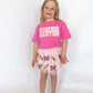 Send your little scholar off in style with the Sweet Wink “Kindergarten” tee! This bright pink shirt is sprinkled with sparkle thanks to its sequin-accented block lettering—perfect for making that first day photo extra special.

Details:

Soft, breathable cotton blend for all-day comfort
Pink sequin “KINDERGARTEN” graphic in bold varsity lettering
Unisex fit for easy styling with skirts, jeans, or leggings
Perfect for first-day-of-school outfits and milestone photos
Available in youth sizes
