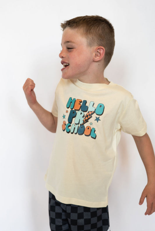 Details:

Soft, lightweight cotton blend for all-day comfort
Cream base with multicolor “HELLO PRESCHOOL” graphic
Unisex fit works great for boys or girls
Ideal for first-day-of-school outfits and milestone photos
Available in youth sizes
