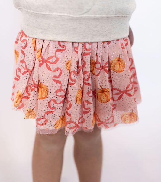 Pink tulle skirt with pumpkin + bow print
Glitter dot accents for extra sparkle ✨
Elastic waistband for comfort + easy fit
Lightweight + twirly design, perfect for layering
Designed by Sweet Wink for festive fall style
📏 Sizes: 2T – 7/8