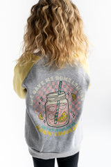 Girl wearing a Raglan Crew with yellow arms, gray base and graphic of lemonade with text " Life gave me some lemons but my Jesus he be makin lemonade" on a white background