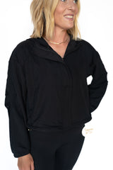 Lightweight, breathable, and perfectly cropped, this zip-up wonder was made for the busy, bold, and always-on-the-move babe. Whether you're headed to pilates, preschool drop-off, or powering through errands like a queen, this jacket’s got your back (literally).

Details:

Lightweight athletic fabric
Full front zip with hidden panel
Adjustable cinchable hem
Built-in hood
Elastic wrist cuffs for secure fit
Slightly cropped length — perfect with high-rise leggings
True black for a sleek, goes-with-everything 
