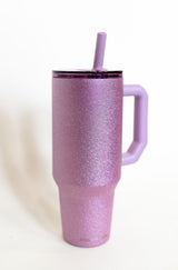 Purple glittery tumbler with a straw on a white background
