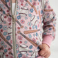 Adorable, lightweight, baseball jacket with flowers, baseball bats and baseballs. Jacket covered in a shimmer fabric. 