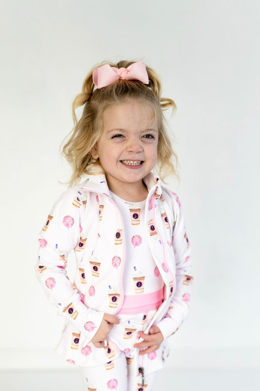 Toddler and youth sized athletic jacket. Pink zipper and pockets. White with fun frappdacino and cake pop graphics