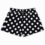 Lulu Mac black shorts featuring a white polka dot print, elastic waistband with Lulu Mac logo, and relaxed fit, displayed on a white background.