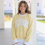 Women's butter yellow and white color-block crewneck sweatshirt featuring oversized white Lulu Mac varsity lettering, ribbed trim, and a relaxed fit.