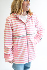 Women wearing a Lulu Mac Darby Raincoat in pink and white stripes. 