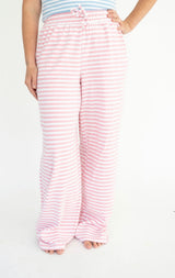 Pink and white striped lounge pants with an elastic drawstring waist, shown on a model against a plain white background.