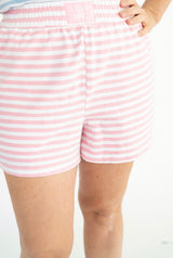 Pink and white striped cotton shorts with an elastic waistband, small logo label says Lulu Mac,  shown on a model from the waist down against a white background.