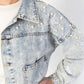 Women's oversized denim wash jean jacket with pearl details, embodied stars and pockets. 