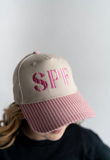SPF embroidered pink seersucker brim women’s trucker hat worn by woman summer boutique baseball cap