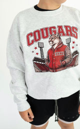 Youth heather gray Cougar Spirit crewneck featuring a red Cougars graphic, cougar mascot in a varsity jacket, and football stadium design.