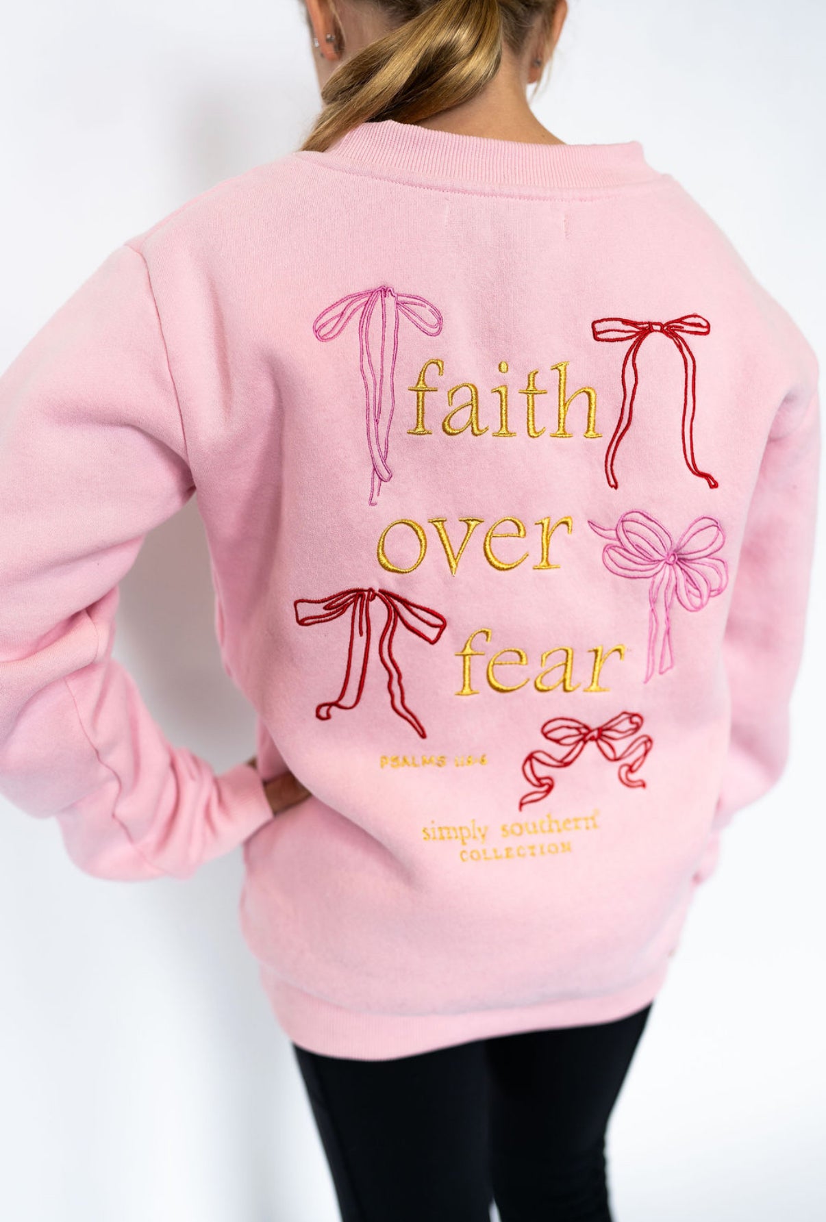 Soft pink crewneck sweatshirt

Front: embroidered bow detail

Back: “Faith Over Fear” embroidery with colorful bows + Psalm 118:6

Cozy cotton blend fabric

Relaxed fit for everyday comfort

Youth sizes S–L